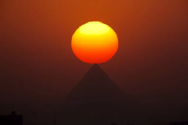 The sun sets over the the Giza Pyramids, near Cairo, Egypt, Friday, August 19, 2016. (Photo by Amr Nabil/AP Photo)