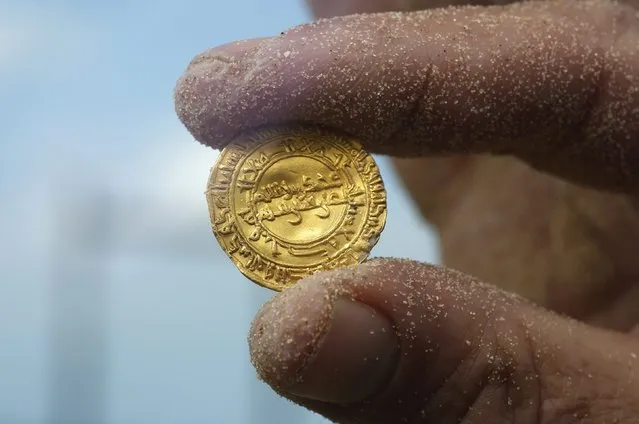 An ancient gold coin is displayed in Caesarea, north of Tel Aviv along the Mediterranean coast February 18, 2015. (Photo by Nir Elias/Reuters)