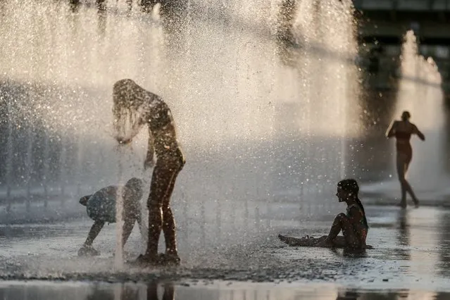 Children play in a fountain on the square in downtown Kyiv, Ukraine, 17 August 2023.   Russian troops entered Ukraine on 24 February 2022 starting a conflict that has provoked destruction and a humanitarian crisis. (Photo by Oleg Petrasyuk/EPA/EFE)