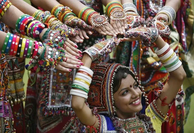 A girl dressed in traditional attire poses as she takes part in rehearsals for the “garba” dance ahead of Navratri festival in the western Indian city of Ahmedabad September 29, 2013. Navratri, held in honour of Hindu Goddess Durga, is celebrated over a period of nine days where thousands of youths dance the night away in traditional costumes. Navratri starts on October 5. (Photo by Amit Dave/Reuters)