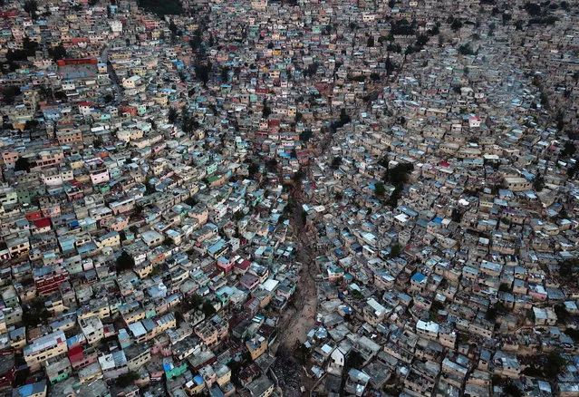 An aerial picture taken on September 27, 2018 shows Jalousie neighborhood in the commune of Petion Ville during the sunset, in the Haitian capital Port-au-Prince. (Photo by Hector Retamal/AFP Photo)
