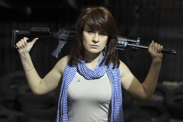 In this Sunday, April 22, 2012 filer, Maria Butina, a gun-rights activist, poses for a photo at a shooting range in Moscow, Russia. Accused of working as an undeclared foreign agent in the U.S., Butina is fast becoming a cause celebre at home. Russian government rhetoric portrays Butina, accused of working as an undeclared foreign agent in the U.S., as a martyr to U.S. paranoia and a victim of poor conditions in the jail where she's being held pending trial. (Photo by Pavel Ptitsin/AP Photo)