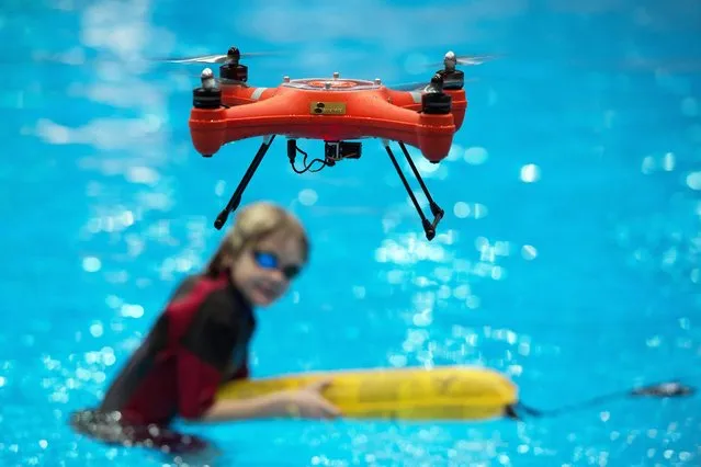 A water proof Splash drone hovering midair after dropping a rescue package for a child in a pool during a press tour at the watersports trade fair Boot in Duesseldorf, Germany, 22 January 2016. The trade fair takes place during 23 and 31 January 2016. (Photo by Federico Gambarini/EPA)