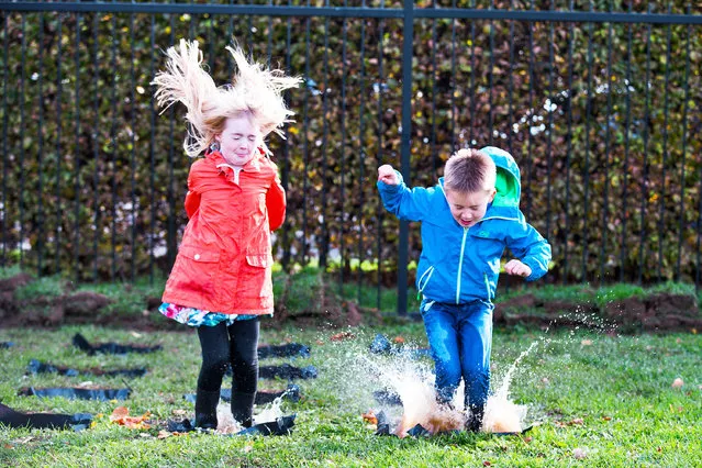 Picture dated October 23rd, 2018 shows brother and sister Henry (7) and Lily Sales (9) getting in some early practice for the World Puddle Jumping Championships at Wicksteed Park in Kettering, Northants, UK. Organisers have made more puddles than ever before in an attempt to make this year's competition the biggest and best yet. They are also hoping competitors will set a new record for the most people jumping in puddles at the same time. Judges will give scores based on the height of the jump, enthusiasm, distance of splash and stickability (the amount of mud which clings to each competitor). (Photo by Geoff Robinson Photography)