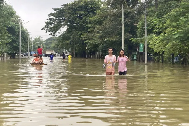 Local residents wade through a flooded road in Bago, about 80 kilometers (50 miles) northeast of Yangon, Myanmar, Monday, October 9, 2023. (Photo by Thein Zaw/AP Photo)