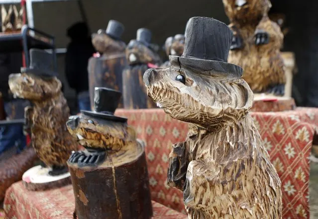 Wooden carvings of top hat wearing groundhogs are for sale at an annual craft show in the square in Punxsutawney, Pa., Monday, February 1, 2016. (Photo by Keith Srakocic/AP Photo)