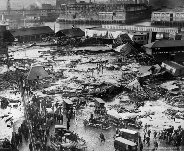 In this January 15, 1919, file photo, the ruins of tanks containing 2 1/2 million gallons of molasses lie in a heap after an eruption that hurled trucks against buildings and crumpled houses in the North End of Boston. Harvard University researchers said in November 2016 that they've solved the mystery behind the disaster that killed 21 people, injured 150 others and flattened buildings when a giant storage tank ruptured. The scientists concluded that the comparatively warm molasses thickened rapidly when exposed to the wintry air, trapping victims in hardening goop. (Photo by AP Photo)
