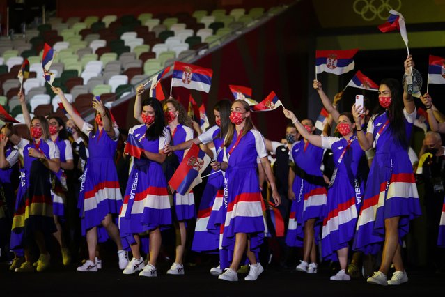 Members of Serbia's delegation take pictures as they parade during the opening ceremony of the Tokyo 2020 Olympic Games, at the Olympic Stadium, in Tokyo, on July 23, 2021. (Photo by Hannah Mckay/Reuters)