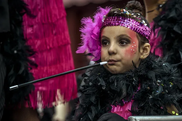 A young reveler in a “golden 20's” costume sits on a float during the children carnival parade in Sitges, Catalonia, Spain on February 7, 2016. (Photo by Matthias Oesterle via ZUMA Wire)
