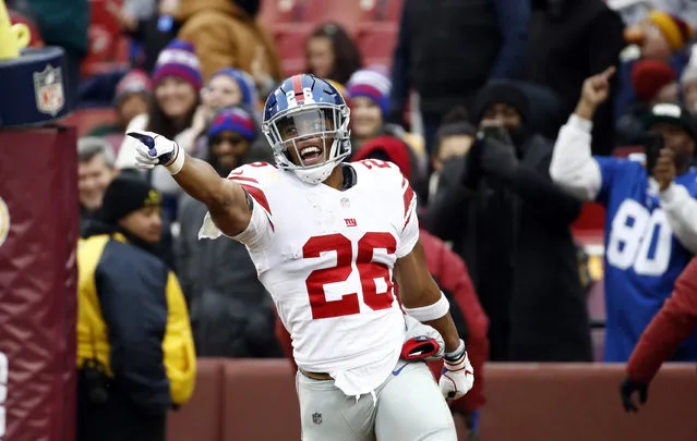 New York Giants running back Saquon Barkley (26) celebrates his 78-yard touchdown during the first half of an NFL football game against the Washington Redskins, Sunday, December 9, 2018, in Landover, Md. (Photo by Patrick Semansky/AP Photo)