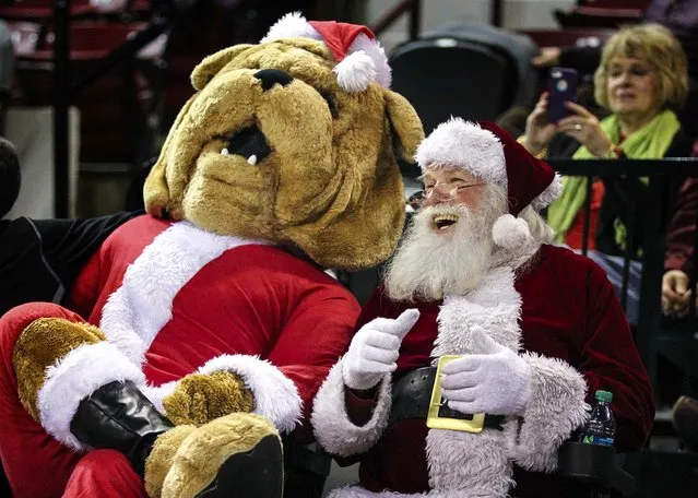 Mississippi State Bulldogs mascot Bully and Santa Claus share a laugh during the game between the Mississippi State Bulldogs and the Florida Gulf Coast Eagles at Humphrey Coliseum, on December 19, 2013. Mississippi State Bulldogs defeat Florida Gulf Coast Eagles 66-53. (Photo by Spruce Derden/USA TODAY Sports)