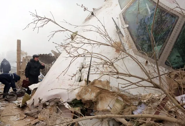 Rescuers work at the site of an airplane crash near the airport Manas, 30 km from Bishkek, Kyrgyzstan, 16 January 2017. A Turkish Boeing 747-400 cargo plane crashed on a village near the capital of Kyrgyzstan, destroying 32 houses and killing at least 37 people, according to reports. (Photo by Igor Kovalenko/EPA)
