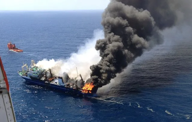 Oleg Neydenov Russian trawler being towed out to sea after a fire broke out on board while it was moored at Las Palmas port on the Spanish Gran Canaria island. The Russian boat that had been accused of illegal fishing sank near the Canary Islands on April 15, 2015, without causing casualties, Spanish rescuers said. (Photo by Salvamento Maritimo/AFP Photo)