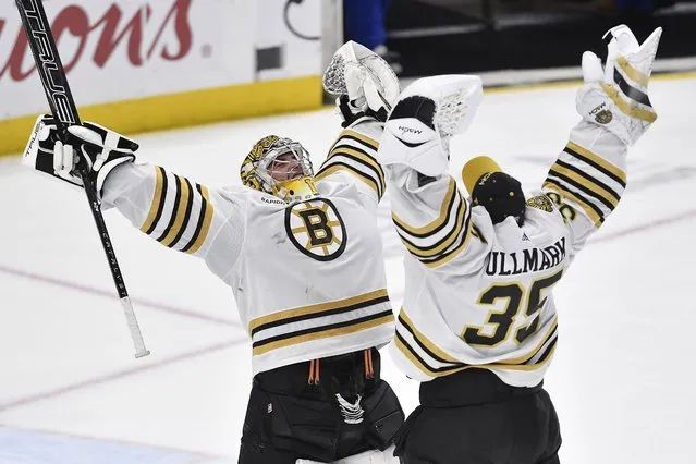 Boston Bruins goalie Jeremy Swayman, left, celebrates with goalie Linus Ullmark after the team's win over the Buffalo Sabres in an NHL hockey game in Buffalo, N.Y., Wednesday, December 27, 2023. (Photo by Adrian Kraus/AP Photo)
