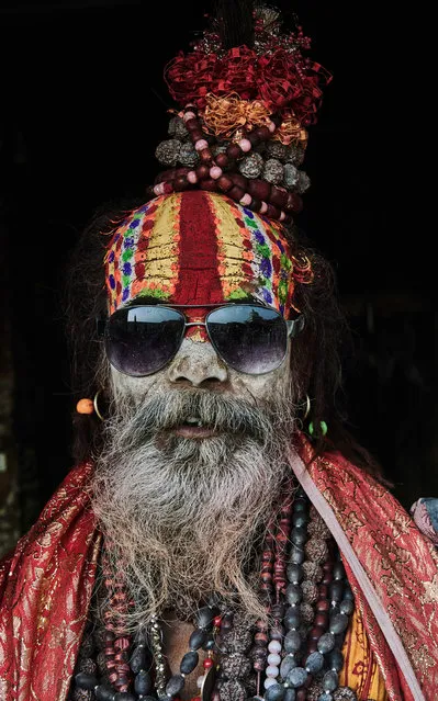 A holy man with a decorative face and headdress wearing sunglasses, taken in Kathmandu, Nepal. (Photo by Jan Moeller Hansen/Barcroft Images)