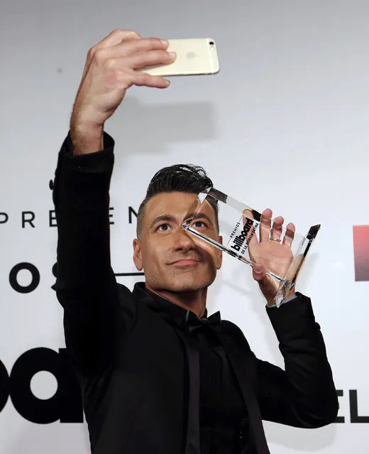 TV host Jorge Bernal shoots a selfie with a Latin Billboard award during the Latin Billboard Awards Thursday, April 30, 2015, in Coral Gables, Fla. Bernal did not win an award. (Photo by Alan Diaz/AP Photo)