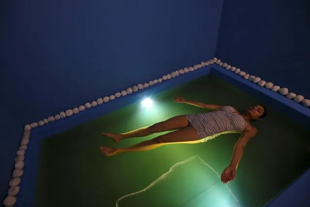 A woman lies in an isolation tank during floatation therapy in Mumbai, India March 28, 2019. (Photo by Francis Mascarenhas/Reuters)