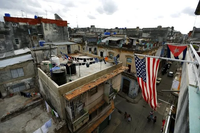 U.S. and Cuban flags are seen on a balcony in Havana, Cuba March 19, 2016. (Photo by Ivan Alvarado/Reuters)