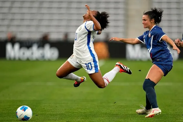 Panama's Marta Cox, left, falls after being fouled by Puerto Rico's Amber Diorio during the first half of a CONCACAF Gold Cup women's soccer tournament match, Saturday, February 24, 2024, in San Diego. (Photo by Gregory Bull/AP Photo)