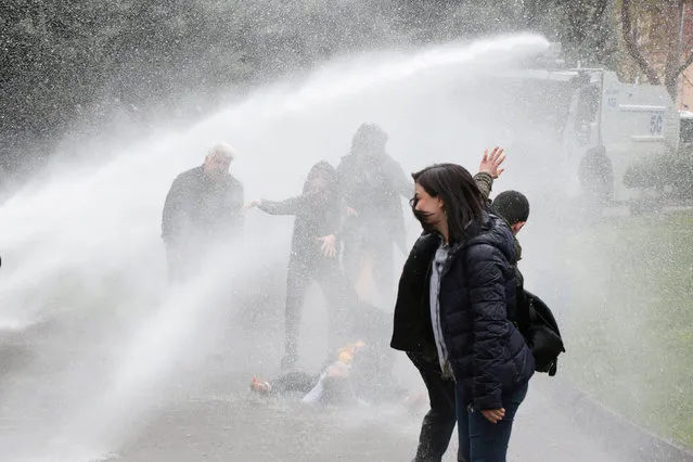 Pro-Kurdish Peoples' Democratic Party (HDP) lawmaker Remziye Tosun falls after being hit by a police water cannon during a protest against results of the local elections, in Diyarbakir, Turkey, April 17, 2019. (Photo by Sertac Kayar/Reuters)
