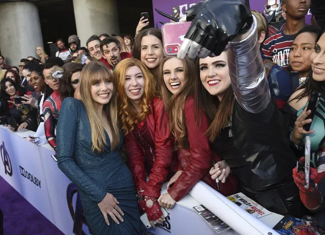 Elizabeth Olsen, left, takes a selfie with fans as she arrives at the premiere of "Avengers: Endgame" at the Los Angeles Convention Center on Monday, April 22, 2019. (Photo by Chris Pizzello/Invision/AP Photo)