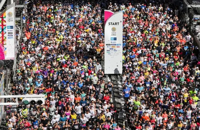 Runners fill the street in front of the Tokyo Metropolitan Government Building at the start of the Tokyo Marathon 2024 in Tokyo on March 3, 2024. (Photo by Kimimasa Mayama/Pool via AFP Photo)