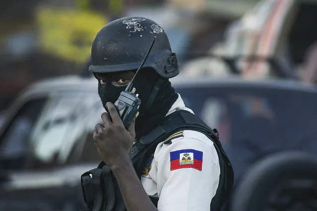 A police officer patrols at an intersection in Port-au-Prince, Haiti, Thursday, November 11, 2021. The U.S. government is urging U.S. citizens to leave Haiti given the country's deepening insecurity and a severe lack of fuel that has affected hospitals, schools and banks. (Photo by Matias Delacroix/AP Photo)