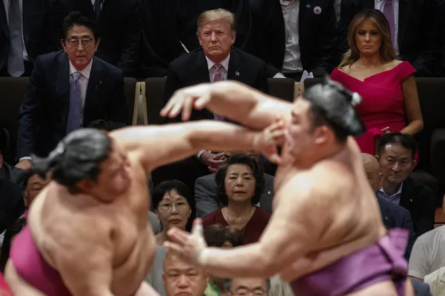 President Donald Trump attends the Tokyo Grand Sumo Tournament with Japanese Prime Minister Shinzo Abe at Ryogoku Kokugikan Stadium, Sunday, May 26, 2019, in Tokyo. First lady Melania Trump is at top right. (Photo by Evan Vucci/AP Photo)