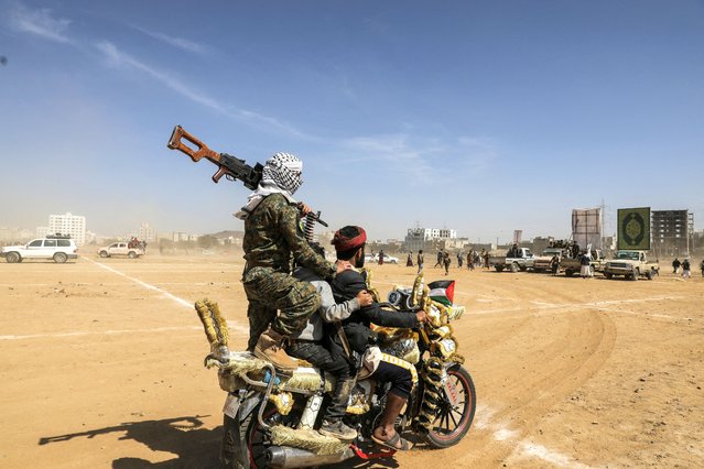 A Houthi follower carries a machine gun as he rides on a motorcycle during a parade in solidarity with the Palestinians in the Gaza Strip and to show support to Houthi strikes on ships in the Red Sea and the Gulf of Aden, in Sanaa, Yemen on January 29, 2024. (Photo by Khaled Abdullah/Reuters)