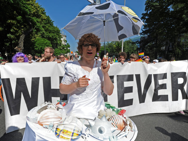 Marchers walk in the annual gay pride parade in Warsaw, Poland, Saturday, June 13, 2015. Gay rights activists hold their 15th yearly "Equality Parade" as Poland slowly grows more accepting of gays and lesbians, but where gay marriage, and even legal partnerships, still appear to be a far-off dream. This year's parade comes amid a right-wing political shift, a possible setback for the LGBT community. (AP Photo/Alik Keplicz)