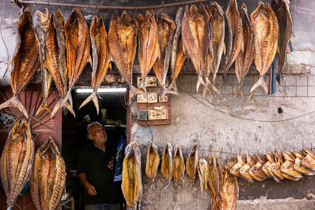An Iraqi man sells dried fish ahead of Eid al-Fitr, which marks the end of the Muslim holy fasting month of Ramadan, in Basra on April 8, 2024. (Photo by Hussein Faleh/AFP Photo)