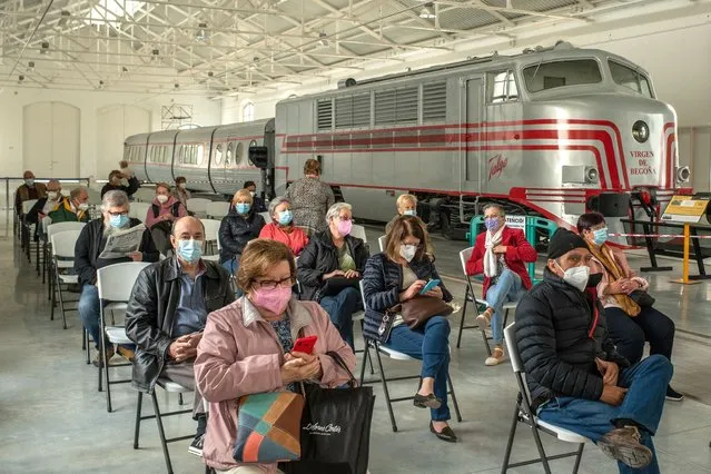 People wait in an observation area next to an historic train after being inoculated with the AstraZeneca COVID-19 vaccine at a vaccination center in the Catalonia Railway Museum on April 15, 2021 in Vilanova i La Geltru, Spain. Spain's Covid-19 vaccination campaign has now moved on to inoculating people in their seventies and high-risk patients, after 95% of the 80-and-over population received their first vaccine dose. (Photo by David Ramos/Getty Images)