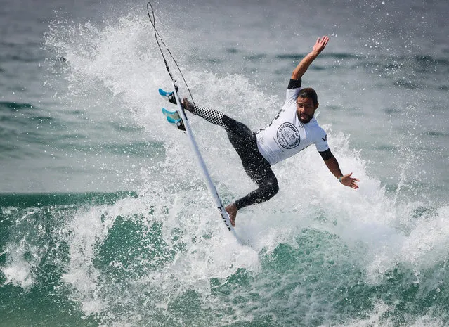 Tomas Hermes of Brazil lands a rotation during round three of the Vans US Open of Surfing held at iconic Huntington Beach, California, on July 30, 2019. (Photo by Mark Ralston/AFP Photo)
