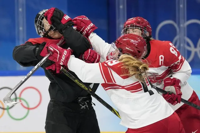 Denmark's Josephine Asperup (19) checks Japan's Rui Ukita, left, during a preliminary round women's hockey game at the 2022 Winter Olympics, Saturday, February 5, 2022, in Beijing. (Photo by Petr David Josek/AP Photo)