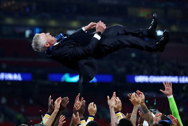 Players of Real Madrid celebrate with head coach of Real Madrid Carlo Ancelotti their victory at the end of the UEFA Champions League final football match between Borussia Dortmund and Real Madrid at Wembley Stadium in London, United Kingdom on June 01, 2024. (Photo by Lee Smith/Reuters)