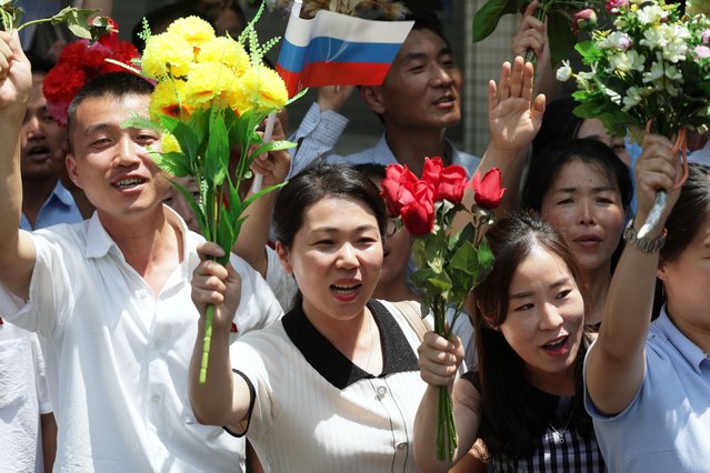North Korean people line up on the street side and welcome the motorcade of Russian President Vladimir Putin and North Korean leader Kim Jong Un during their meeting in Pyongyang, North Korea, 19 June 2024. The Russian president is on a state visit to North Korea from 18-19 June at the invitation of the North Korean leader. He last visited North Korea in 2000, shortly after his first inauguration as president. (Photo by Gavriil Grigorov/EPA/EFE)