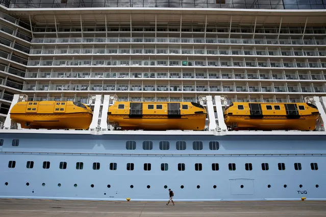 A passenger walks towards a terminal after disembarking the “Ovation of the Seas” cruise ship at the port of Piraeus, near Athens, Greece, May 15, 2016. (Photo by Alkis Konstantinidis/Reuters)