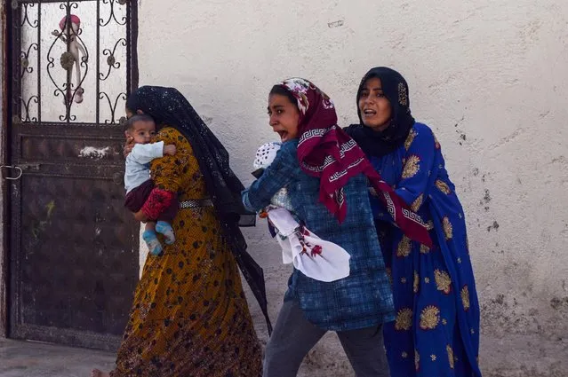 Women run out of their home after a rocket fired from Syria landed in their neighborhood in the Turkish border town of Akcakale in Sanliurfa province, Turkey, October 10, 2019. (Photo by Ismail Coskun (IHA) via Reuters)