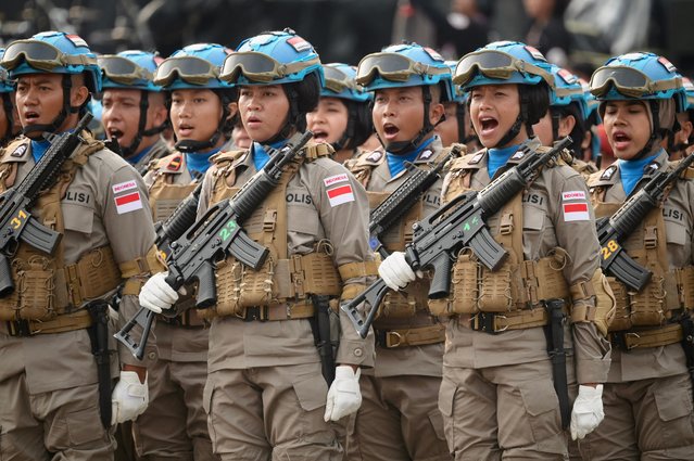 Indonesian police personnel as part of a UN peacekeeping force shout slogans during a ceremony commemorating the 78th Indonesian Police Day in Jakarta on July 1, 2024. (Photo by Bay Ismoyo/AFP Photo)