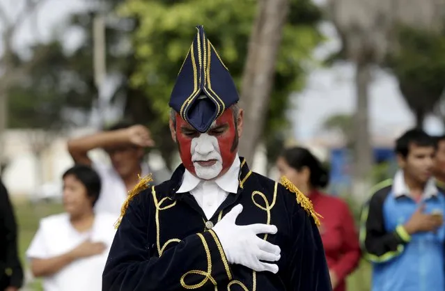 A patient in military costume sings the national anthem during a parade, as part of Independence Day celebrations, at the Larco Herrera psychiatric hospital in Lima July 22, 2015. (Photo by Mariana Bazo/Reuters)