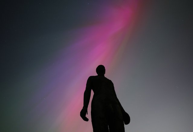 The Aurora Borealis, known as the Northern Lights, is visible behind Anthony Gormley's “Another Place” sculpture in Crosby, Britain, 10 May 2024. (Photo by Adam Vaughan/EPA/EFE/Rex Features/Shutterstock)