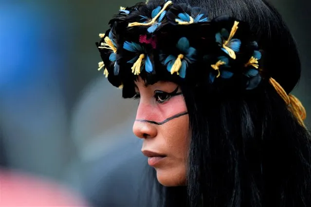 An indigenous woman looks on during the Terra Livre (Free Land) camp, a protest-camp to defend indigenous land and cultural rights that they say are threatened by the right-wing government of Brazil's President Jair Bolsonaro, in Brasilia, Brazil on April 4, 2022. (Photo by Adriano Machado/Reuters)