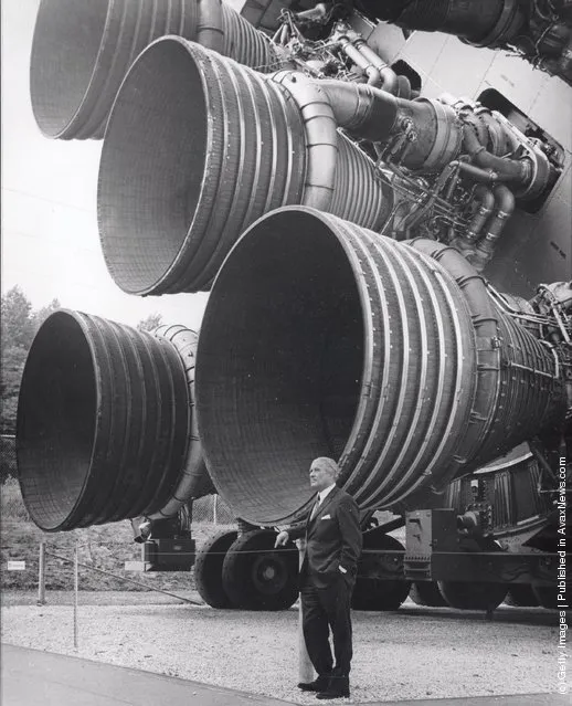 In this handout from NASA/Marshall Space Flight Center. Dr. Wernher von Braun stands next to F-1 Engines of the Saturn V launch vehicle