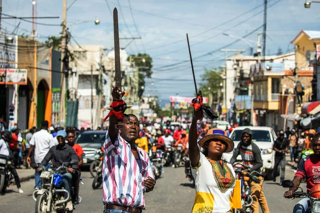Haitians take to the streets to protest over the increasing insecurity in the Haitian capital Port-au-Prince, on March 29, 2022. (Photo by Valerie Baeriswyl/AFP Photo)