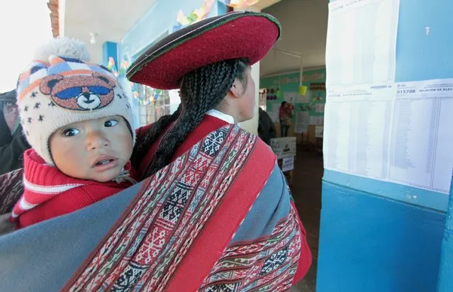 An indigenous woman from a village deep in the Andes votes at a polling station in the southeastern Peruvian town of Urubamba, an hour away from Cuzco, on June 5, 2016. Some residents in this highland area have walked up to 75 kilometers to attend their civic duty. Peruvians voted Sunday in a close-fought runoff election that will decide whether Pedro Pablo Kuczynski or Keiko Fujimori, the daughter of former president Alberto Fujimori, in jail for corruption and crimes against humanity, will be their new leader. (Photo by AFP Photo/Stringer)