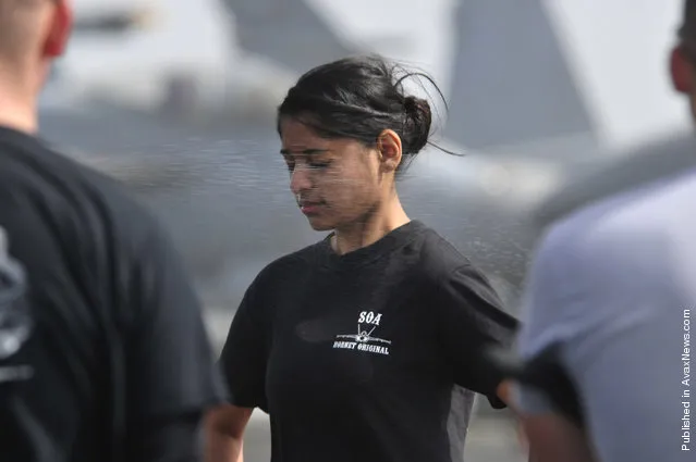 Operations Specialist 2nd Class Jenna Rainbolt, temporarily assigned to the security department aboard the Nimitz-class aircraft carrier USS Carl Vinson (CVN 70), is sprayed with Oleoresin Capsicum (OC) spray during security academy OC spray qualifications