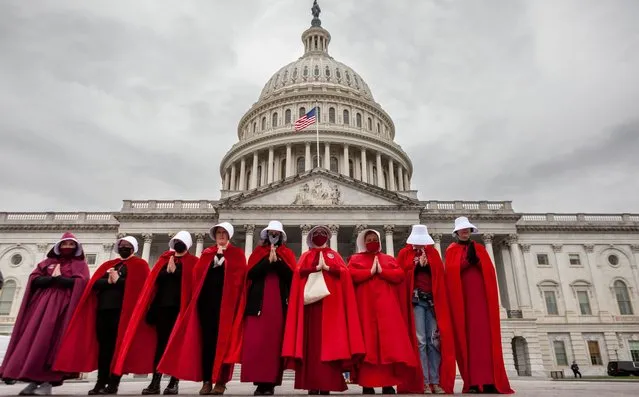 Demonstrators dressed as handmaids from “The Handmaid's Tale”, stand in front of the Capitol on May 8, 2022 during a protest by the Handmaids Army DC of the Supreme Court's leaked preliminary decision to overturn Roe v. Wade. (Photo by Allison Bailey/NurPhoto/Rex Features/Shutterstock)