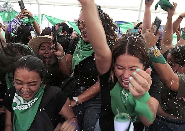 Women celebrate the law that decriminalizes the legal interruption of pregnancy in Chilpancingo, state of Guerrero, Mexico, 17 May 2022. The Congress of the state of Guerrero, southern Mexico, approved a law that allows the legal interruption of pregnancy up to 12 weeks of gestation. With 30 votes in favor, 13 against, one null and one abstention, Guerrero became the eighth state in Mexico to approve said law. (Photo by Jose Luis de la Cruz/EPA/EFE)