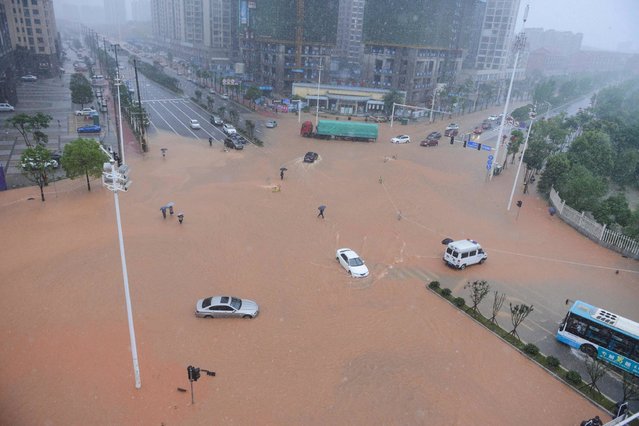 This picture taken on July 2, 2017 shows an aerial view of a flooded street in Changsha, Hunan province. Days of torrential rain in Hunan province raised the water level of the Xiangjiang river to exceed its record flood level. (Photo by AFP Photo/Stringer)