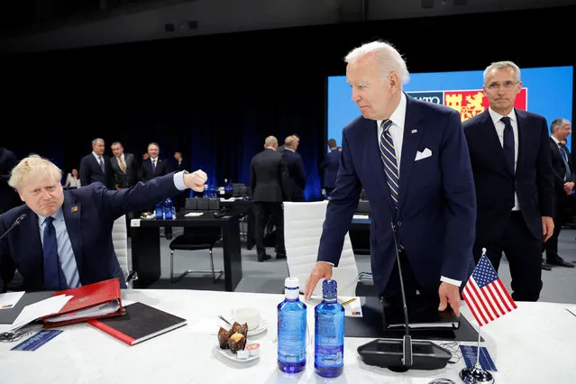 US President Joe Biden (C) looks towards Britain's Prime Minister Boris Johnson (L) as NATO Secretary General Jens Stoltenberg (R) looks on ahead of a meeting of The North Atlantic Council during the NATO summit at the Ifema congress centre in Madrid, on June 30, 2022. (Photo by Jonathan Ernst/Pool via AFP Photo)